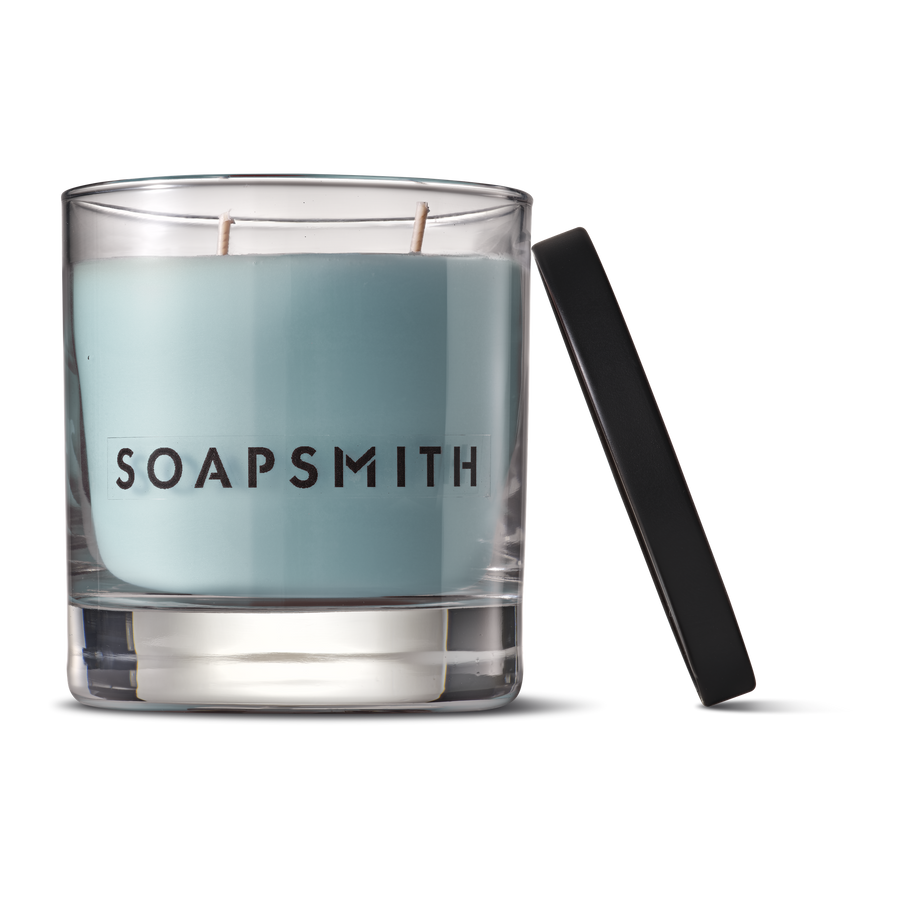 King’s Road two-wick candle with lid beside the glass