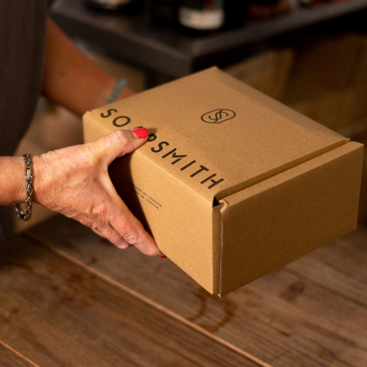 Hands finishing a Soapsmith parcel