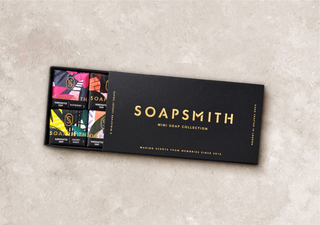 Soapsmith Mini Soap Collection gift box, partly open to show the colourful wrapped soaps on a cream background.