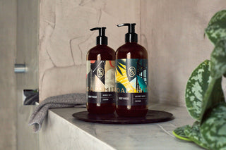 Hackney Marsh and Marble Arch 500ml Body Wash bottles on a bathroom tray.