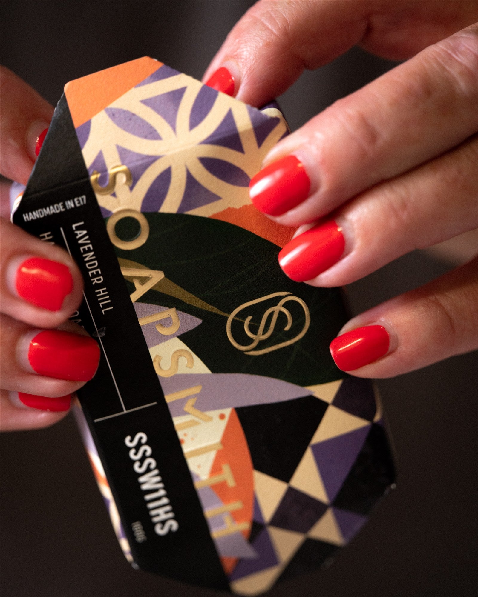 A Soapsmith soap bar being wrapped by hand